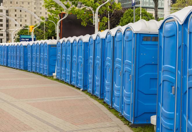 a fleet of portable restrooms ready for use at a large outdoor wedding or celebration in Clay Center KS